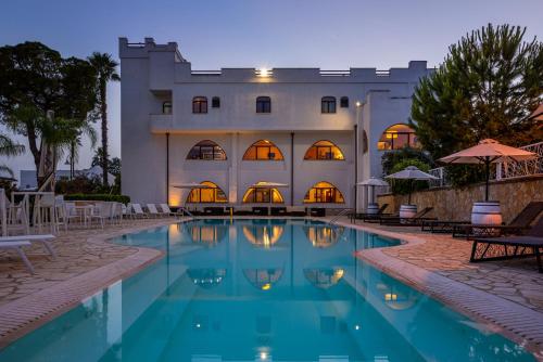 a swimming pool in front of a building at Leone de Castris Wine Hotel in Salice Salentino