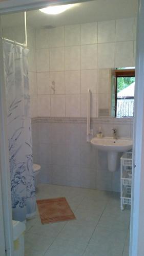 a bathroom with a sink and a toilet and a mirror at Gościniec Mazurski in Mrągowo
