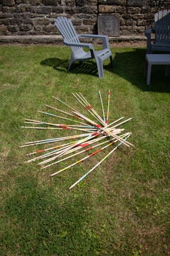 a pile of sticks on the grass next to a bench at "Chez la Joe" in Thélonne