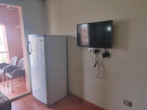 a flat screen tv on the corner of a room at one bedroom chalet porto south Families only in Ain Sokhna