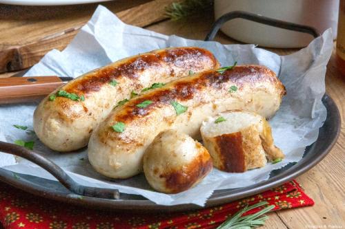 a plate of sausages and muffins on a table at "Chez la Joe" in Thélonne