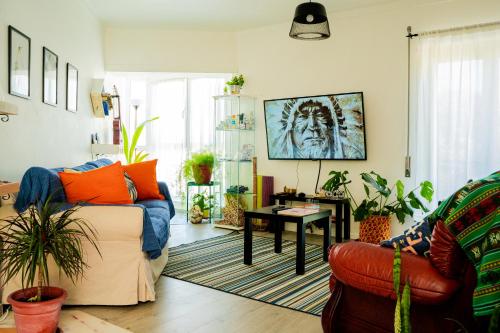 a living room with a couch and a table at Paz & Amor Guest House - Peace & Love in Nazaré