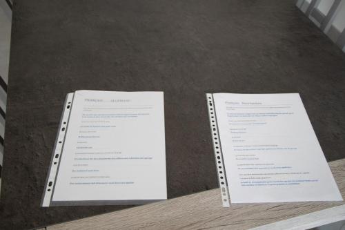 two sheets of paper sitting on top of a table at "Chez la Joe" in Thélonne