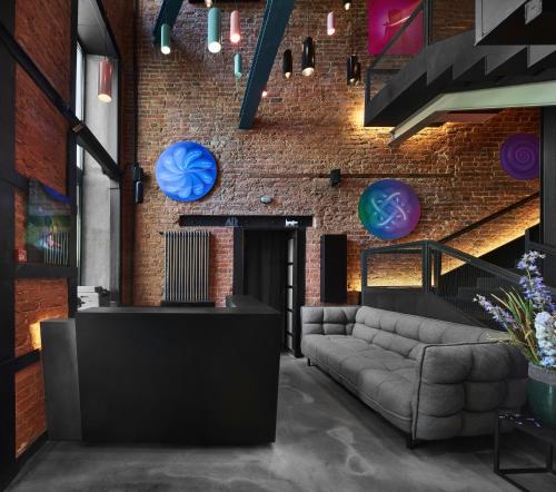 a living room with a couch and a brick wall at WYNWOOD Hotel in Saint Petersburg