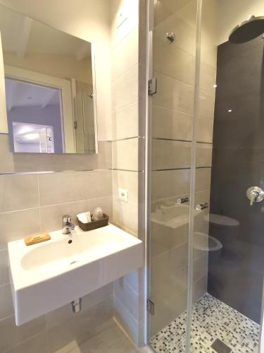 a bathroom with a sink and a shower at Le Métro in Carini