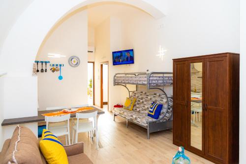 a living room with a couch and a table and a bunk bed at Living Bouganville in Trapani