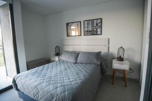 a bedroom with a bed and two night stands at Del Cerro Alquiler Temporario in Tandil