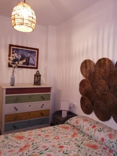 a bedroom with a bed and a dresser at Tío Genaro in Cumbres de San Bartolomé