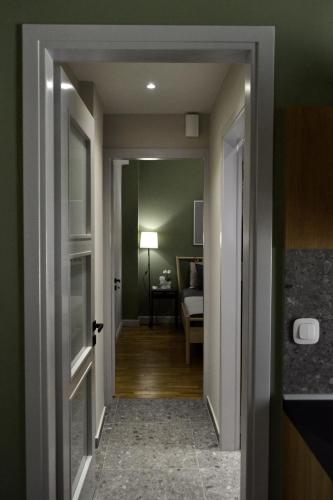 a hallway with a door leading to a bedroom at GREEN HOUSE in Kardítsa