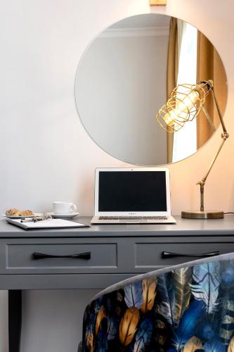 a desk with a laptop on it with a mirror at LAGUN CASTLE HOTEL&SPA in Yalova