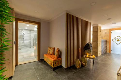 a bathroom with a shower and a chair in a room at LAGUN CASTLE HOTEL&SPA in Yalova