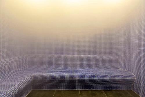 a bathroom with purple tiles on the wall at LAGUN CASTLE HOTEL&SPA in Yalova