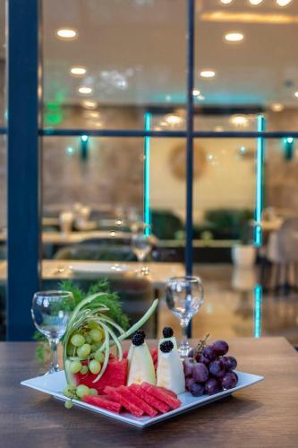 a plate of food on a table with wine glasses at LAGUN CASTLE HOTEL&SPA in Yalova