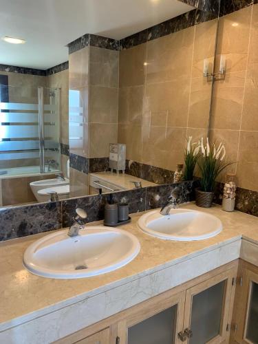 two sinks in a bathroom with a large mirror at SEA & CASTILLO VIEW in Castillo de Sabinillas
