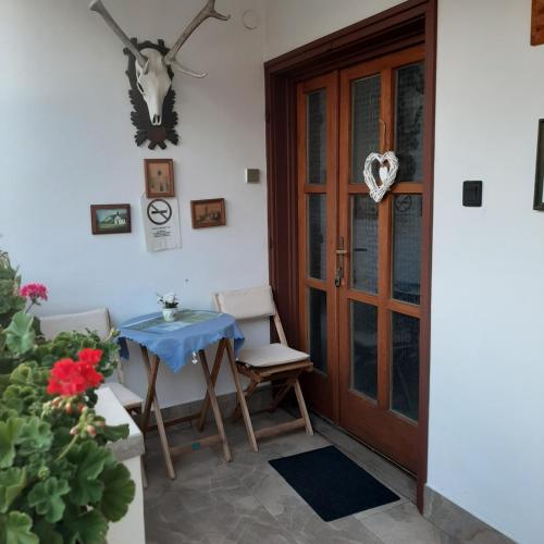 a table and chairs in front of a door at Rózsa Vendégház in Visegrád