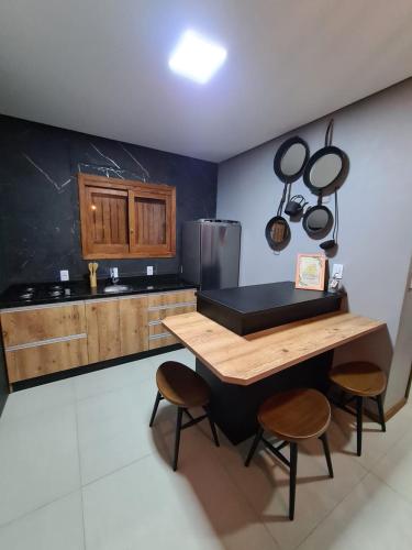 a kitchen with a table and some pots and pans at Refúgio dos Coiotes in Cambara do Sul