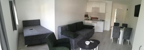 a small living room with a couch and a table at Vila Leolaz in Višegrad