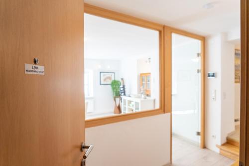 an open door to a room with a mirror at Modern Apartment in the City Center of Bad Ischl in Bad Ischl