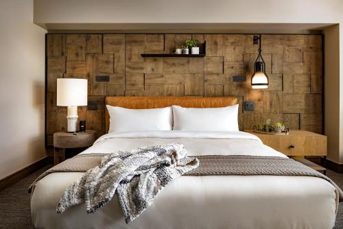 a bedroom with a large bed with a wooden wall at 1 Hotel San Francisco in San Francisco