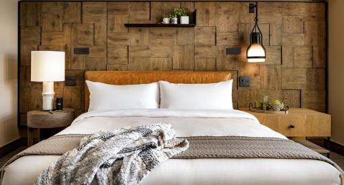 a bedroom with a bed and a wooden wall at 1 Hotel San Francisco in San Francisco