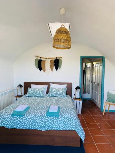 a bedroom with a large bed with blue and white sheets at Beach House Loft in Cortegaça