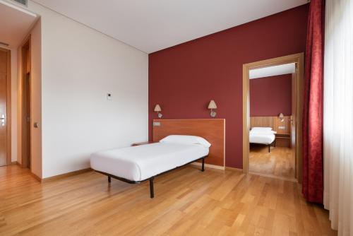 Säng eller sängar i ett rum på Exe Vía Argentum