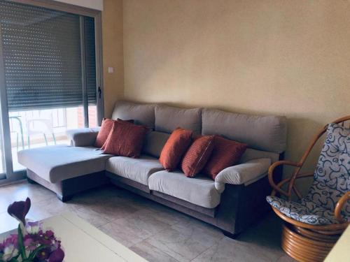 a couch in a living room with pillows on it at Piso lujoso in Puerto de Mazarrón