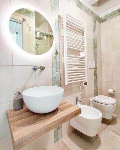 a bathroom with a white sink and a toilet at RomAntica in Polignano a Mare