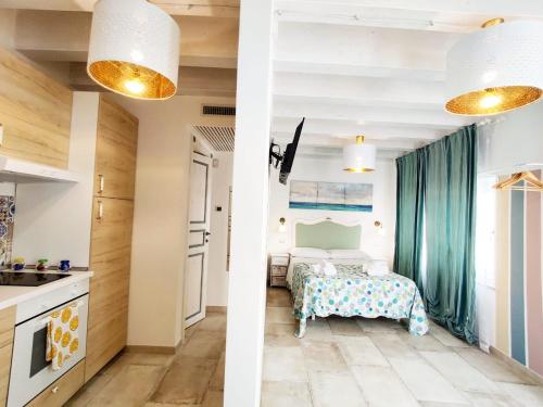 a kitchen and a bedroom with a bed at RomAntica in Polignano a Mare