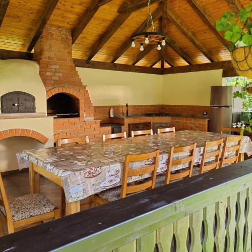 a large kitchen with a large stone table and chairs at Pensiunea casa Rareș in Curtea de Argeş