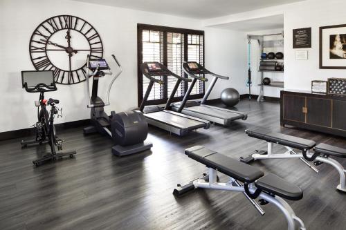 a gym with a large clock and several exercise bikes at Ambrose Hotel in Los Angeles