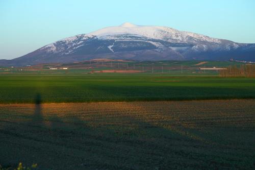 a snow covered mountain in the middle of a field at Vivienda Turística Los Mesones in Ágreda
