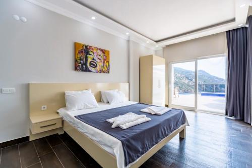 a bedroom with a bed with two towels on it at LA VILLA CELINE- Luxury Sea View Villa with Private Infinity Pool in Islamlar-Kalkan in Kalkan
