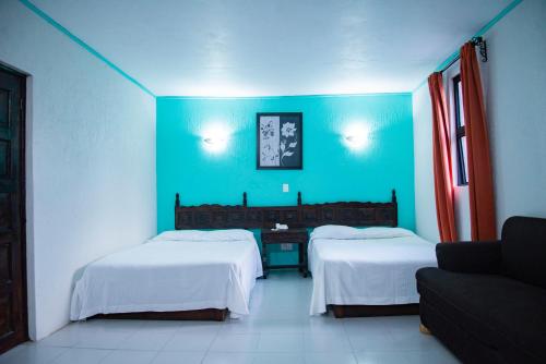 Ein Bett oder Betten in einem Zimmer der Unterkunft Hotel Hacienda de Cobos