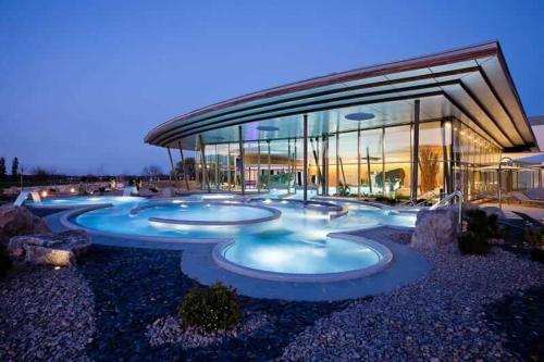 a building with four pools in front of it at Appartement au cœur du Val d'Argent in Sainte-Croix-aux-Mines