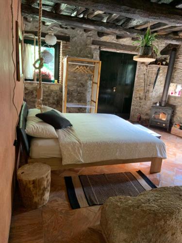 a bedroom with a large bed and a fireplace at Il Mulino di Valeria in Canzo