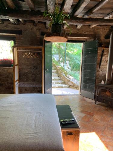 a bedroom with a bed and a large doorway at Il Mulino di Valeria in Canzo