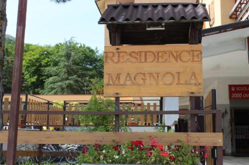 a sign for a restaurant in front of a building at Fiocco di neve, residence Magnola in Ovindoli