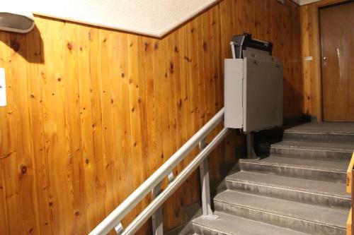 a set of stairs in a room with wooden walls at Fiocco di neve, residence Magnola in Ovindoli