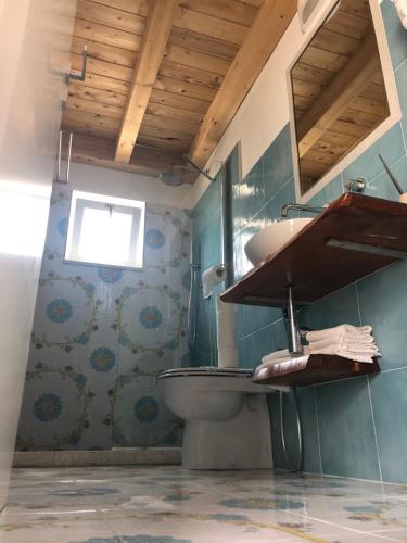 a bathroom with a sink and a toilet at Rena Resort in Mondragone