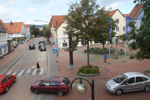 a city street with cars parked on the street at Deutsches Haus in Springe