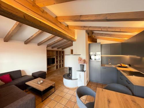 a kitchen and living room with a couch and a table at Sonnenschein Appartement Rebecca in Kirchberg in Tirol
