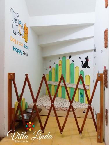 a bedroom with a bed with a surfboard wall at Villa Linda ApartaHotel in Jericó