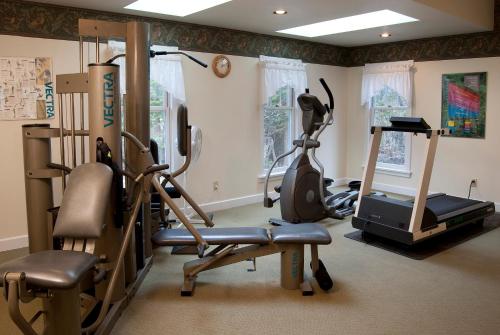 a gym with a treadmill and exercise equipment in a room at Eagle Harbor Inn in Ephraim