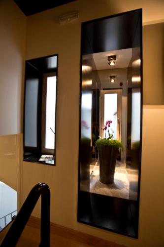 a mirror in a hallway with a potted plant at Borelli Palace & Borelli Blue in Zadar
