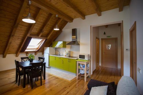 a kitchen and dining room with a table in a room at Hotel Rural Aribe Irati in Aribe