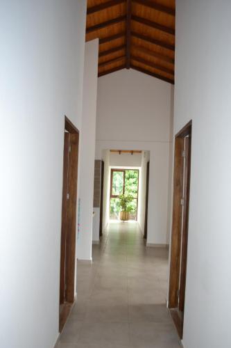 an empty hallway with wooden doors in a building at Condominio Atlantis in Coveñas