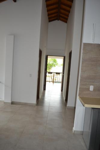 a hallway with white walls and a tile floor at Condominio Atlantis in Coveñas