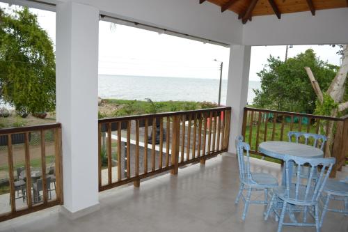 a balcony with a table and chairs and the ocean at Condominio Atlantis in Coveñas