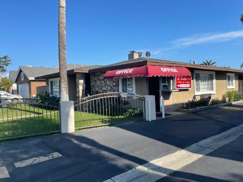 a store with a red awning on a building at Legacy inn & suites in Anaheim